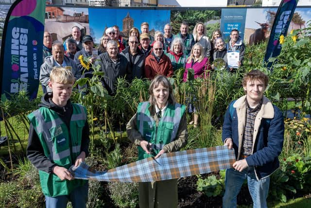 The new Meanwhile Garden at Callendar Riggs was officially opened on Friday.  Jacquie Balfour does the honours of cutting the ribbon with help from volunteers Joshua Ovens, 15, and Shane Montague, 17.  (Pic: Michael Gillen)