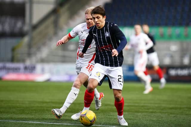 Charlie Telfer drives with the ball to avoid the attentions of Aaron Splaine against Clyde in the 2-1 defeat