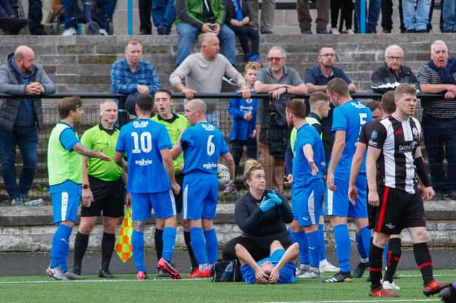 Zander Miller lies in agony on the pitch after sustaining an ankle break during Saturday's clash against Wick (Pic by Scott Louden)