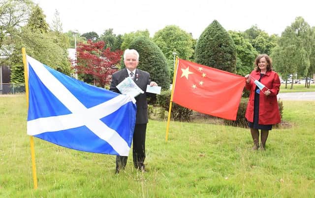 Provost William Buchanan hands over the masks donated from the Yueqing Peoples Government in China to Patricia Cassidy, chief officer of the Falkirk Health and Social Care Partnership.