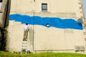 Artist Scott Gilbert has been commissioned by Strathcarron Hospice to create a mural in Denny to mark the service's 40th year. Picture: Ailsa Herd.