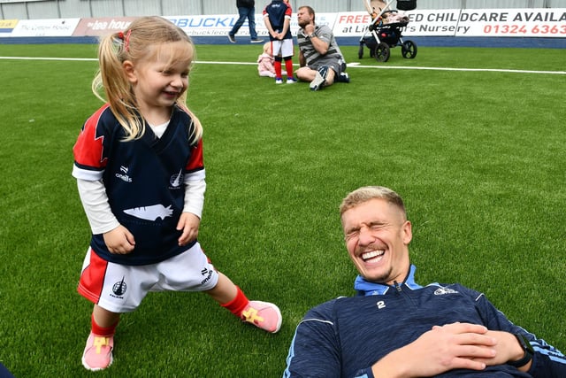Defender Tom Lang enjoying the day with a Junior Bairn