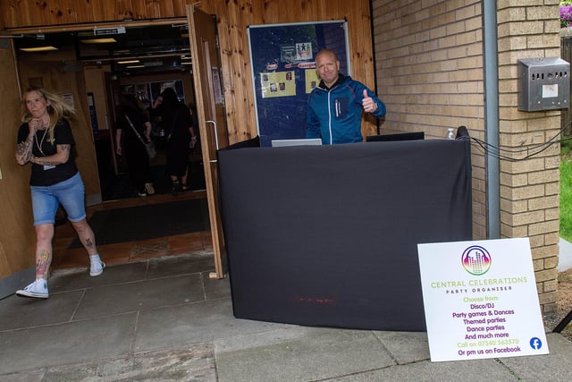 A DJ was at the door of the community centre to encourage people to attend.