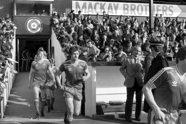 Dougie Bell runs onto the pitch before the Hearts v Aberdeen football match at Tynecastle in October 1980.