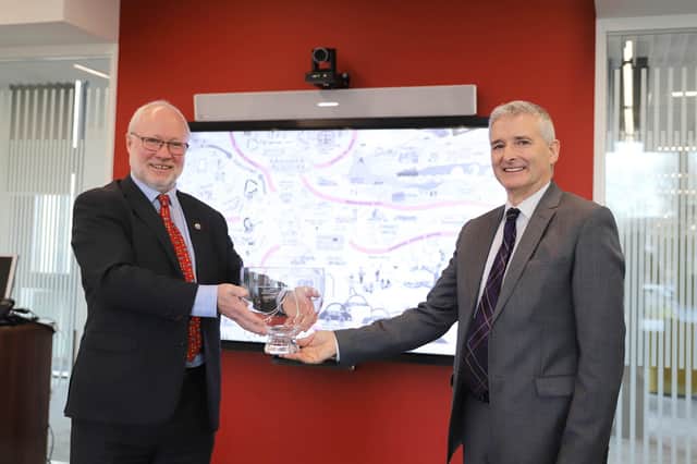 Dr Thomson receives his award from Aidan O’Carroll, who chairs the  Institute of Directors Scotland