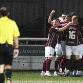 Michael Anderson is mobbed by his teammates after scoring (Photo: Michael Gillen)