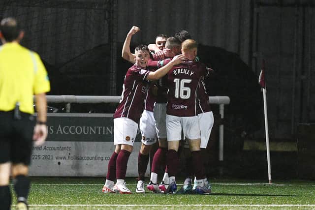 Michael Anderson is mobbed by his teammates after scoring (Photo: Michael Gillen)