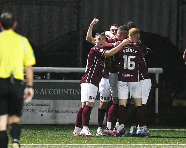 Michael Anderson is mobbed by his teammates after scoring (Photo: Michael Gillen)