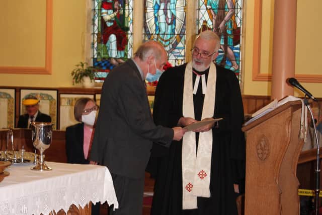 Ian Crozier of Grahamston United Church receives a certificate from Rev. Paul Whittle to mark 50 years as an ordained Elder