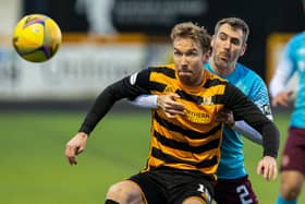 New Stenhousemuir signing Robert Thomson holding off Michael Smith during a Scottish Championship match between Alloa Athletic and Heart of Midlothian in January 2021 (Photo by Bruce White/SNS Group)