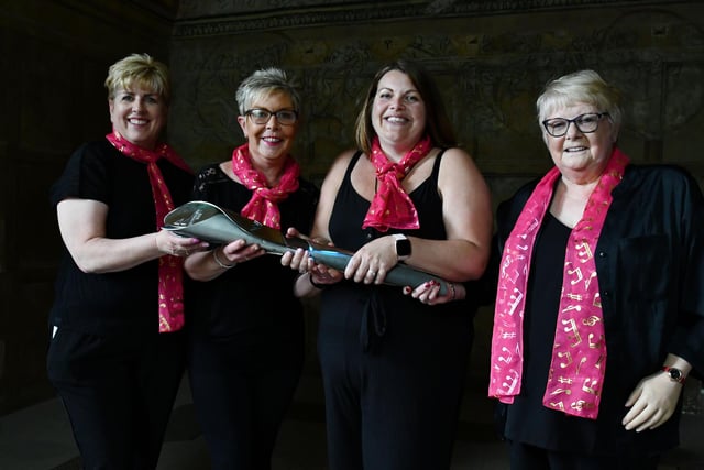 Members of the  Sing Forth Choir with the baton which will arrive in Birmingham next month