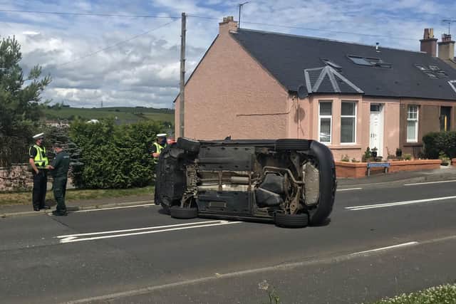 A car crashed onto its side on Allandale's main road in June. Picture: Alastair Fairley.