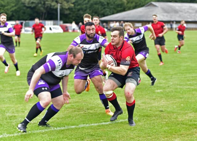 Linlithgow's Ross Plenderleith about to be tackled by the Royal High defenders during the sides' previous league meeting on September 25 (Pic by Graham Black)