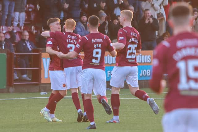Yates is mobbed by his teammates after putting the Warriors ahead against Stranraer