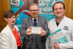 Martyn Day is pictured holding an example of a 3D organ on a chip, a cutting edge new approach method used in medical research. He is pictured next to CEO of Animal Free Research UK Carla Owen (left) and Queen Mary University London cancer research scientist, Dr Adrian Biddle. (Photo Credit AFRUK/Andrew Parsons).