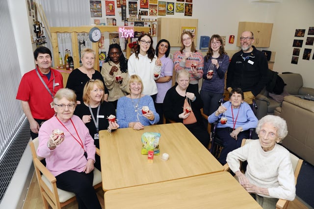 Pupils from St Mungo's and Falkirk High School working with residents to make bird feeders.