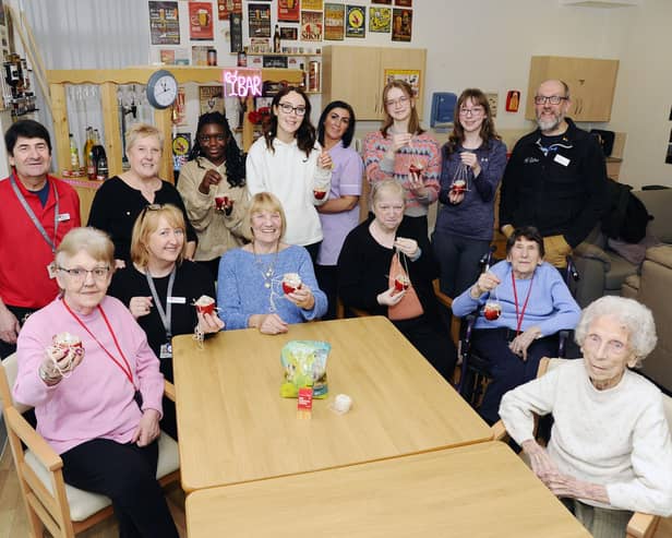 Pupils from St Mungo's and Falkirk High School working with residents to make bird feeders.