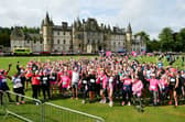 Participants in the 10k event get warmed up with the backdrop of Callendar House.