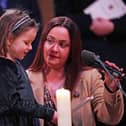 Mila Sneddon, six, reading a prayer, accompanied by her mother Lynda Sneddon, during 'Royal Carols - Together At Christmas', a Christmas carol concert hosted by the Duchess of Cambridge at Westminster Abbey in London, which will be broadcast on Christmas Eve on ITV. Pic:  Yui Mok/PA Wire