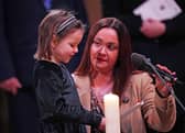 Mila Sneddon, six, reading a prayer, accompanied by her mother Lynda Sneddon, during 'Royal Carols - Together At Christmas', a Christmas carol concert hosted by the Duchess of Cambridge at Westminster Abbey in London, which will be broadcast on Christmas Eve on ITV. Pic:  Yui Mok/PA Wire