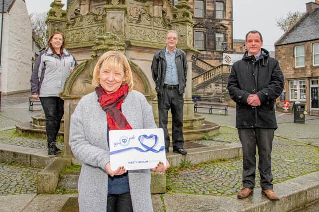 Pictured launching the Scotland Loves Local West Lothian Gift Card at Linlithgow Cross are, left to right, One Linlithgow chair Evelyn Noble, Councilllor Cathy Muldoon, Chair of Broxburn and Uphall Traders' Association Gordon Allan and Nairn Pearson from West Lothian Council. Photo by Paul Watt.