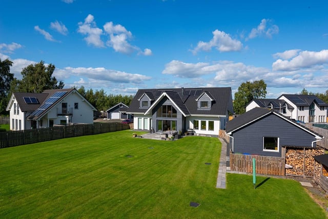 Externally, the property has a large multi-car driveway that leads to a substantial detached garage. Doors from the living area open directly onto a large patio and a substantial rear garden. The garden is enclosed by a timber fence and looks onto woodland at the rear of the property. There is plenty of potential for extensive landscaping.