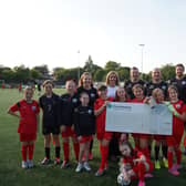 Euan Stainbank alongside Lisa Riley and members of the Dunipace FC girls team. (Pic. Contributed.)
