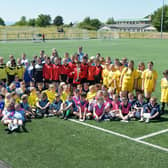 Pupils from Bo'ness primary schools enjoyed a football tournament in memory of former Deanburn pupil Jay Young.  Pictured are the participating schools with winners Bo'ness Public Primary (centre) and members of Jay's family - mum Emma Young, brother Logan, gran Lesley Young and cousin Blake Sneddon.  (Picture: Michael Gillen)