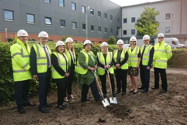 Gillian Morton and Cathie Cowan (with spades) with some of the team working behind the scenes on the new National Treatment Centre.