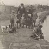 A group of adults and children on the Union Canal towpath, 1920.