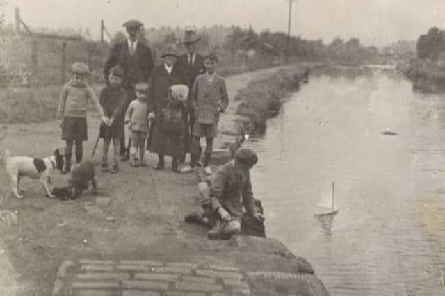 A group of adults and children on the Union Canal towpath, 1920.