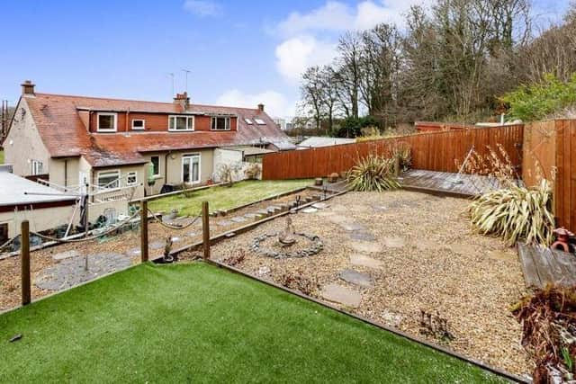 South-facing rear garden has been professionally landscaped, with its own neuks to enjoy.