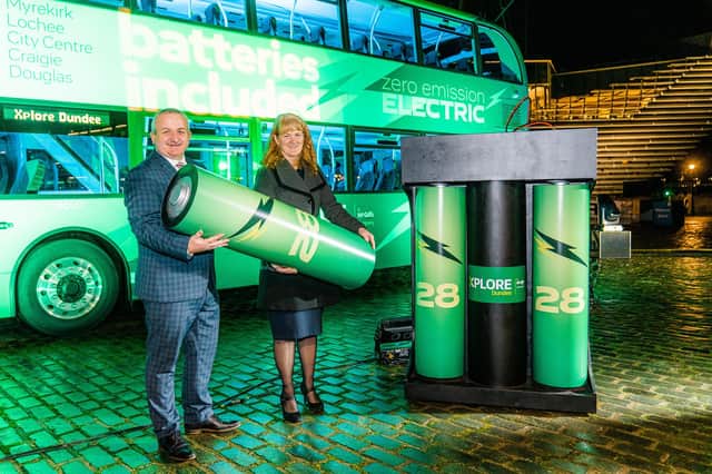 Charlie Miller, ADL Sales Account Manager, with Christine McGlasson holding BYD’s Iron-Phosphate batteries used to power the bus.