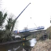 The new footbridge, linking Brightons and Polmont, is hoisted into the air over the Union Canal. Picture: Lisa Evans/Falkirk Council.