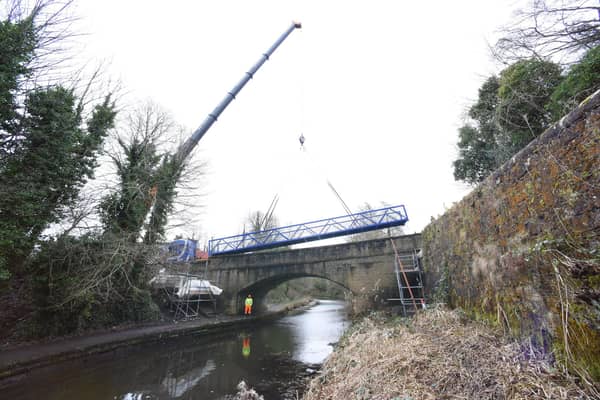 The new footbridge, linking Brightons and Polmont, is hoisted into the air over the Union Canal. Picture: Lisa Evans/Falkirk Council.