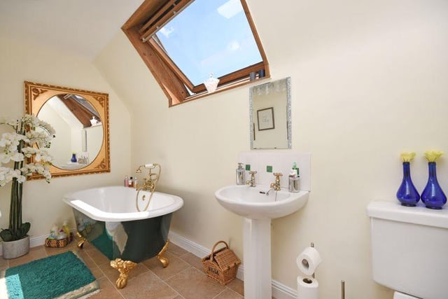This bathroom also has a clawfoot bathtub and a skylight.