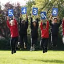 Pupils from Stenhouse Primary School, Edinburgh holding up cards showing the new estimate of the population during the launch of the first results from Scotland's Census 2022