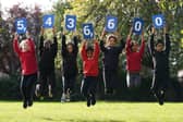 Pupils from Stenhouse Primary School, Edinburgh holding up cards showing the new estimate of the population during the launch of the first results from Scotland's Census 2022