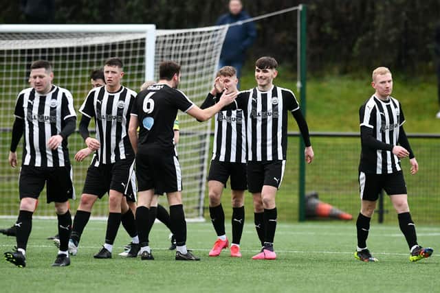 Sam Colley celebrates with his teammates after putting Dunipace 2-0 up against Camelon on Saturday (Pics by Michael Gillen)