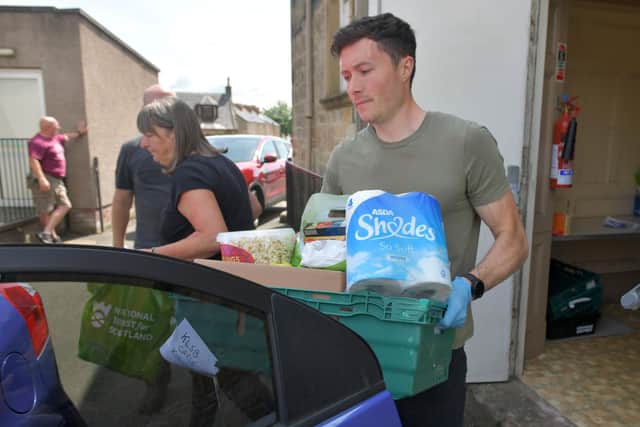 Keeping Larbert and Stenhousemuir Beautiful Community Pantry (KLSB Community Pantry) volunteers and Stenhousemuir FC Community Help Initiative loading cars and distributing food parcels to those in need and self-isolating.