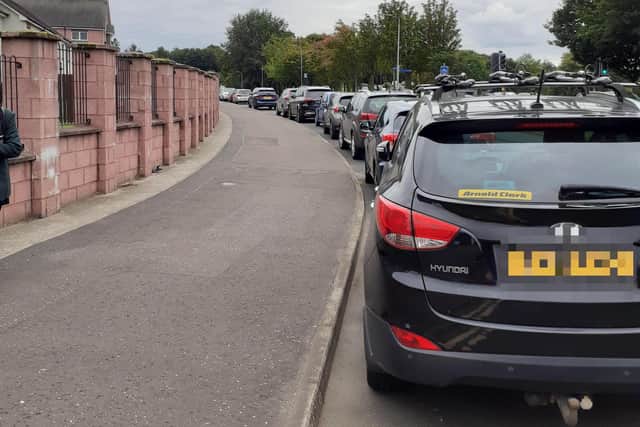 Cars parked in a line outside the schools
