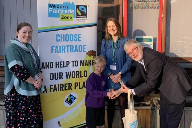 Ethan from Linlithgow Bridge Primary, the P1 to P4 winner, receives his prize from Ian Fowell, Linlithgow Fairtrade Partnership chairman.