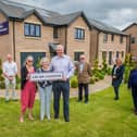 Elizabeth Grubb with her son Rhoderick and daughter Mhairi with Councillor Kevin Lang, Councillor Louise Young, Keith Gimlett (QDCC) and Taylor Wimpey sales executives Jacquie Bryson Elder and Helen Allenby. Photo - Chris Watt