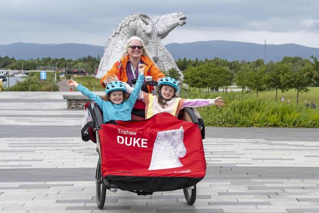 Lois Friel, aged 8 (left) and Rosa Hepburn, aged 8 (right) hitch a ride with Shauna Brown (Cycling Without Age Scotland) to celebrate the launch of Visit Falkirk’s cycling tourism campaign