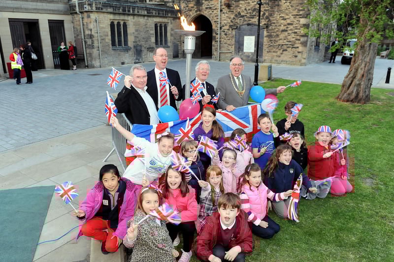 Alex McQuade, Falkirk Community Trust board member; Neil Brown, general manager Falkirk Community Trust; Depute Provost John Patrick; Provost Pat Reid and local children with the beacon.