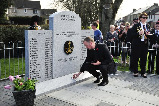 Reverend Andrew Moor of Bothkennar & Carronshore church lays a wooden cross at the memorial