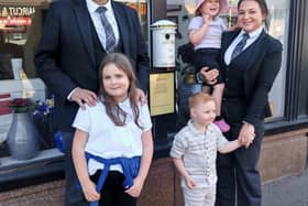 Paul O'Connor and Danielle McDougall with the children using the post box at their premises in High Street, Bonnybridge. Pic: Contributed
