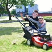 Two members of the Carr family's grass cutting dream team, Beancross Primary pupils David (11) and William (9)