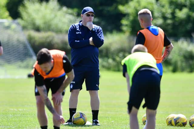 Manager John McGlynn speaks to the players during a training session at Little Kerse (Photos: Michael Gillen)