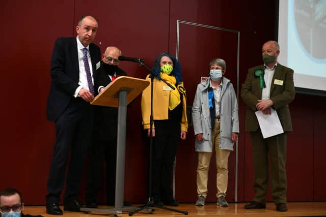 Returning officer Kenneth Lawrie announces the SNP victory as the four candidates look on